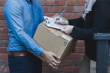man-signing-for-shipping-box - KENJI KOI Products